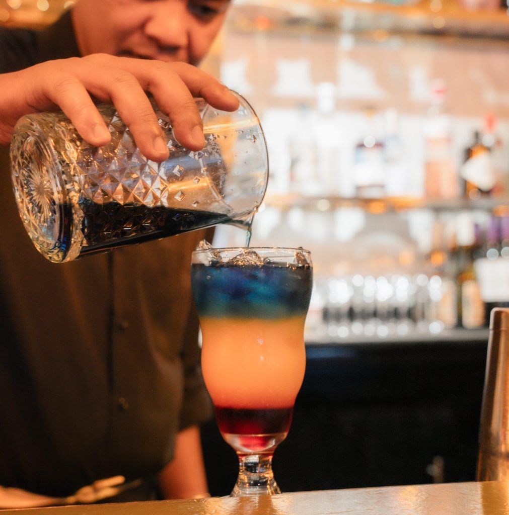 Bartender mixing a mocktail at a Bite Club restaurant in Cayman