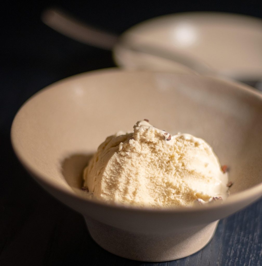 A scoop of vanilla ice cream served in a restaurant, highlighting desserts available at Bite Club restaurants in the Cayman Islands.